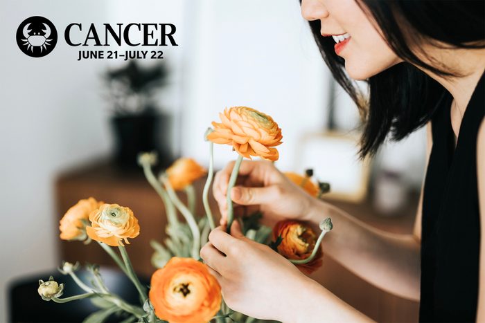 woman arranging fresh flowers at home