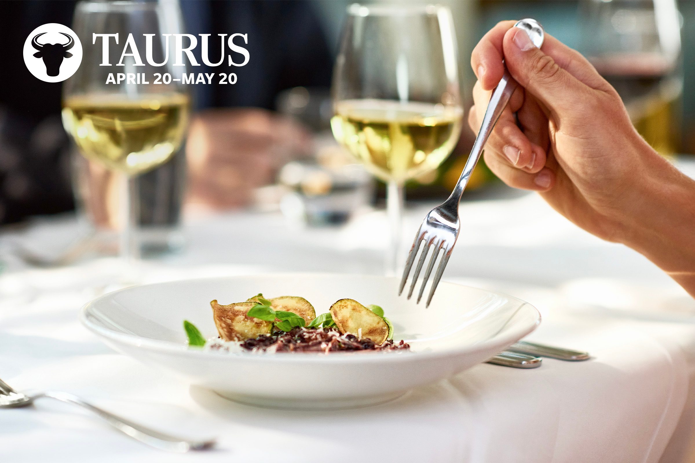 fine dinning plate with white wine glasses in background