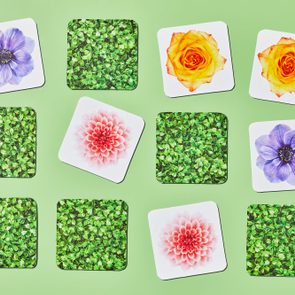 memory card game tiles featuring flowers are arranged on green background