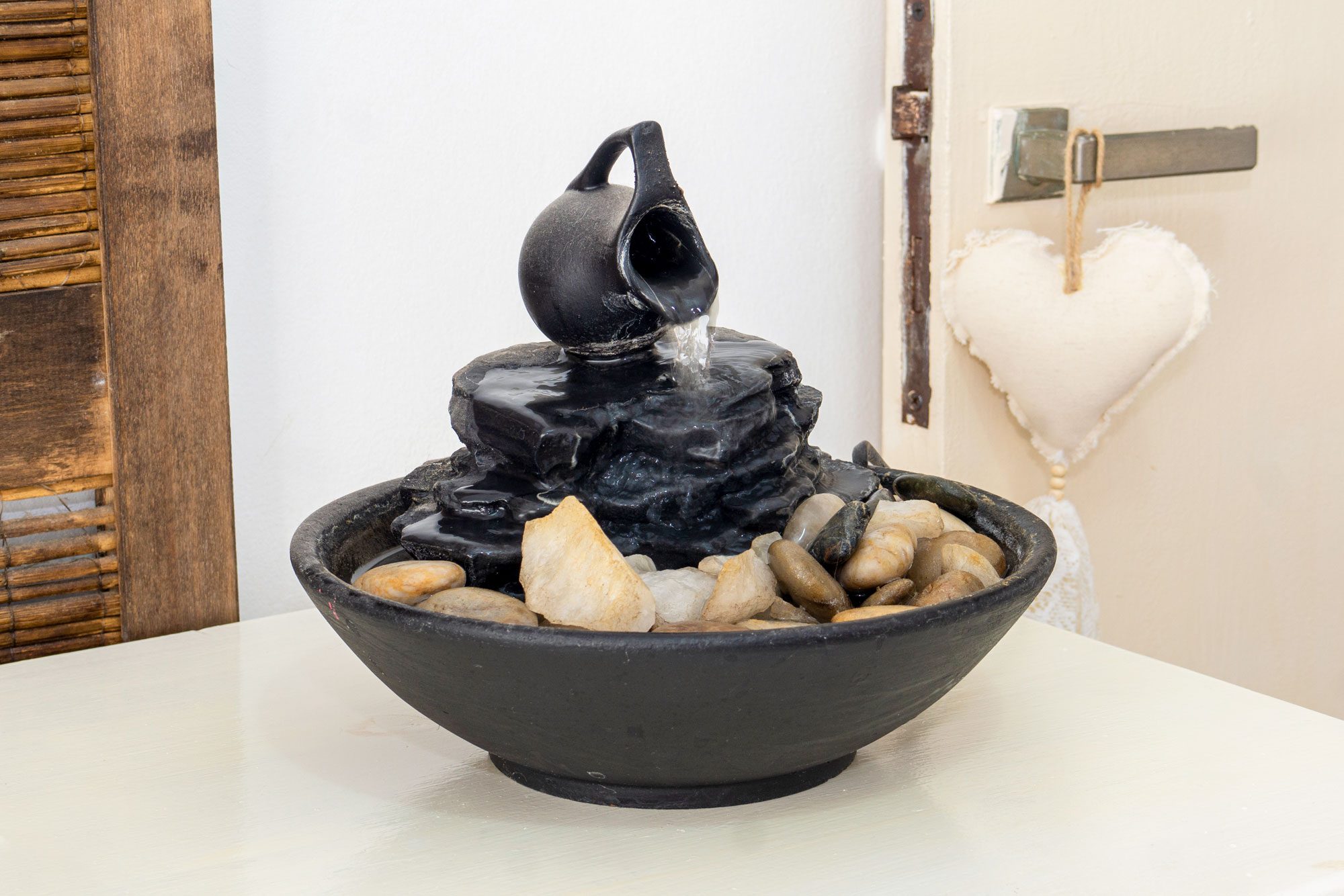 Zen Water Fountain On Top Of A Small White Table