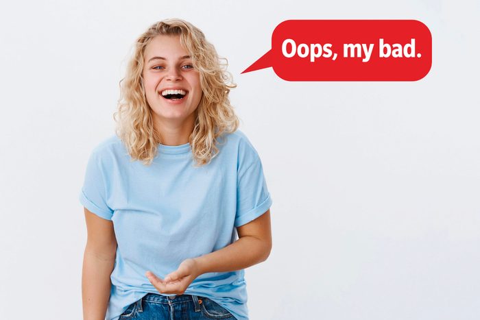 Laughing woman delivering a comeback roast, speech bubble text: "Oops, my bad."