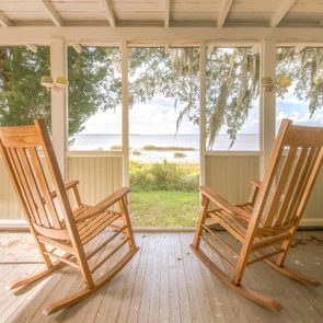 Pair Of Old Rocking Chairs On A Porch Overlooking An Inlet At Sapelo Island, Georgia