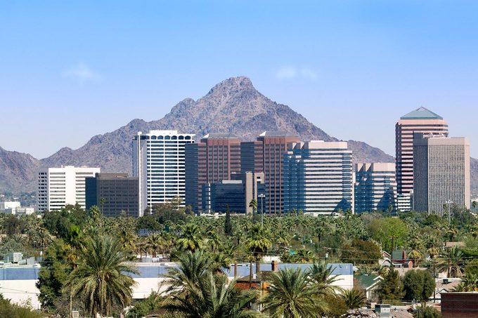 Downtown Scottsdale And Suburbs Of Phoenix with the White Tank Mountain Range in the background on a bright blue sky day