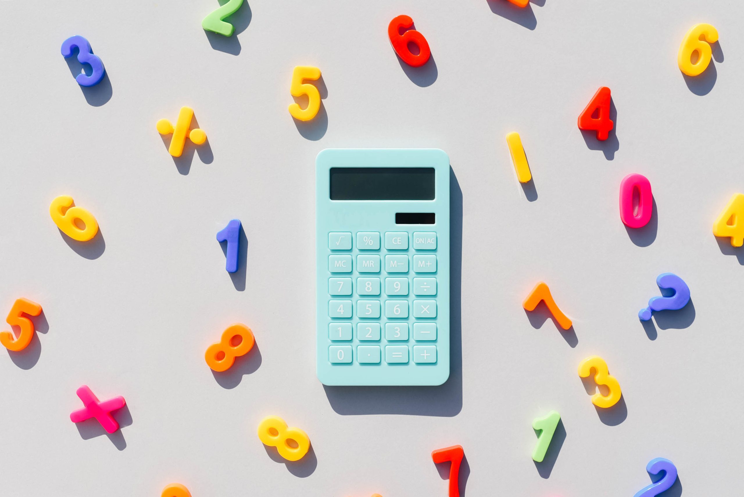 Blue calculator and math symbols on a universal gray background. Gray background. Blue calculator. Math symbols.