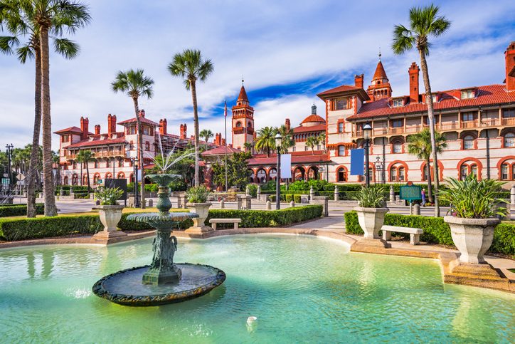 The Town Square in St. Augustine Florida on a bright sunny day with fountains, palm trees and terracotta roof buildings