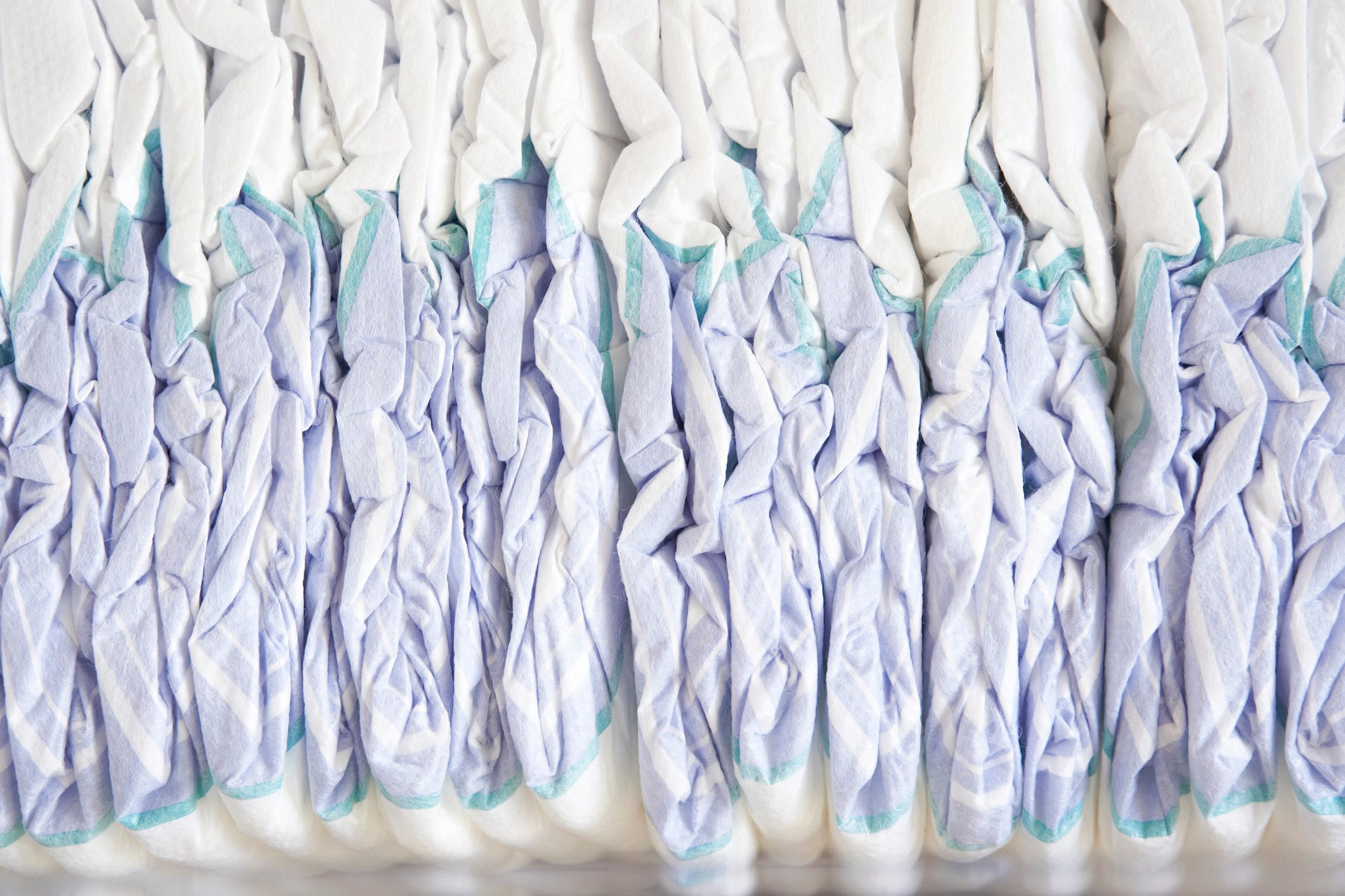 close up on side view of a pile of disposable diapers