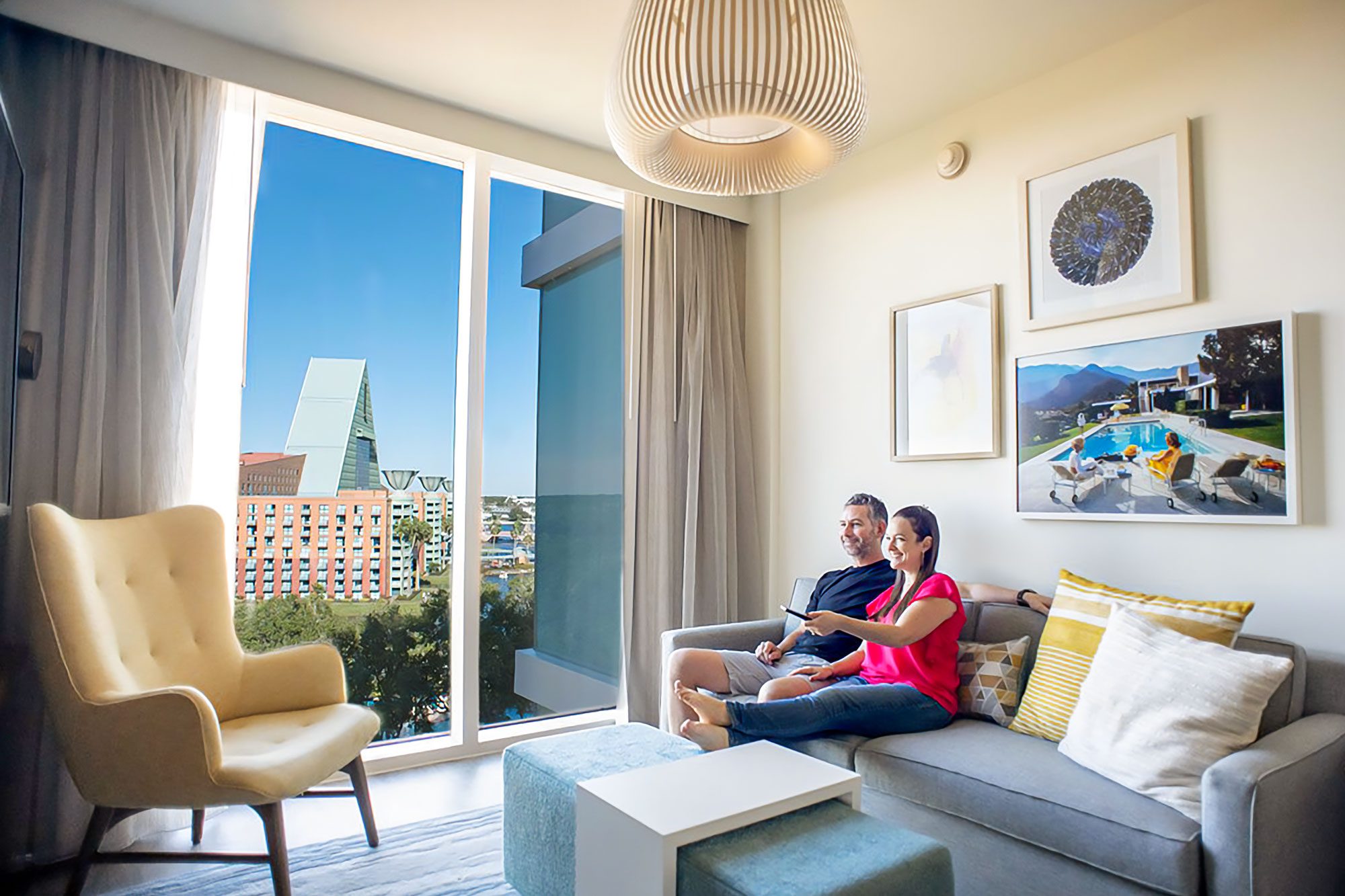 A Couple Sitting on a Couch in a Hotel Room of Walt Disney World