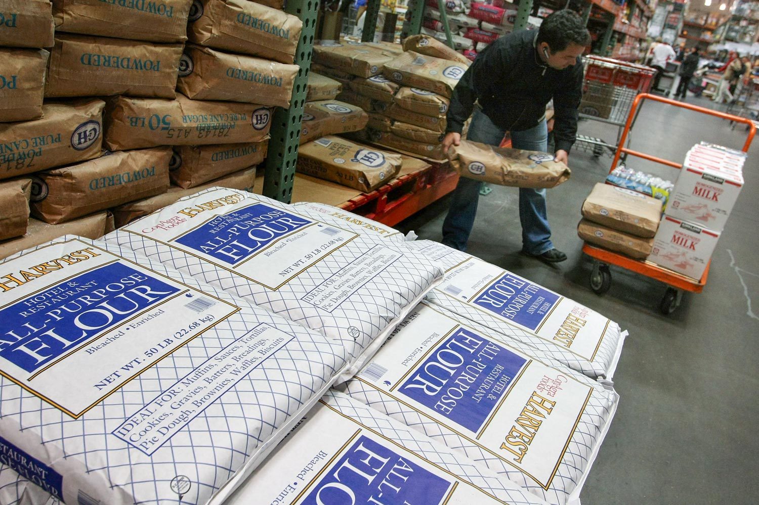 Industrial Kitchen Grade Bags of Flour are stacked on a pallet and for sale at a Costco Wholesale Store in San Francisco, California