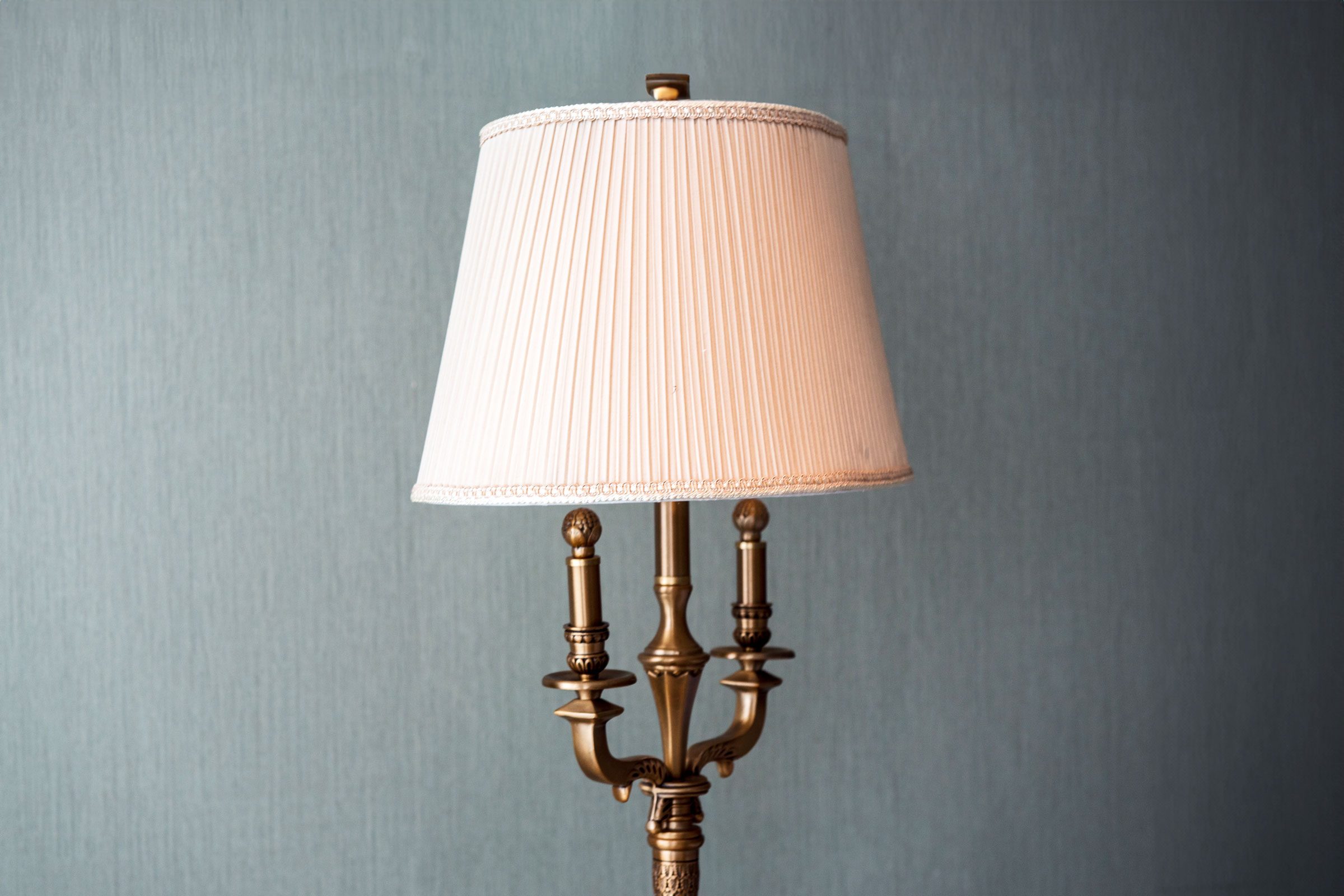 old lamp against a blue wall