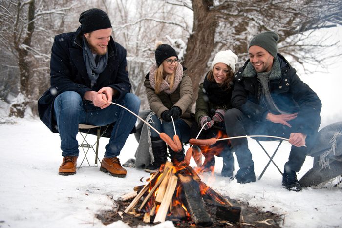 Friends having barbecue on a snowy day