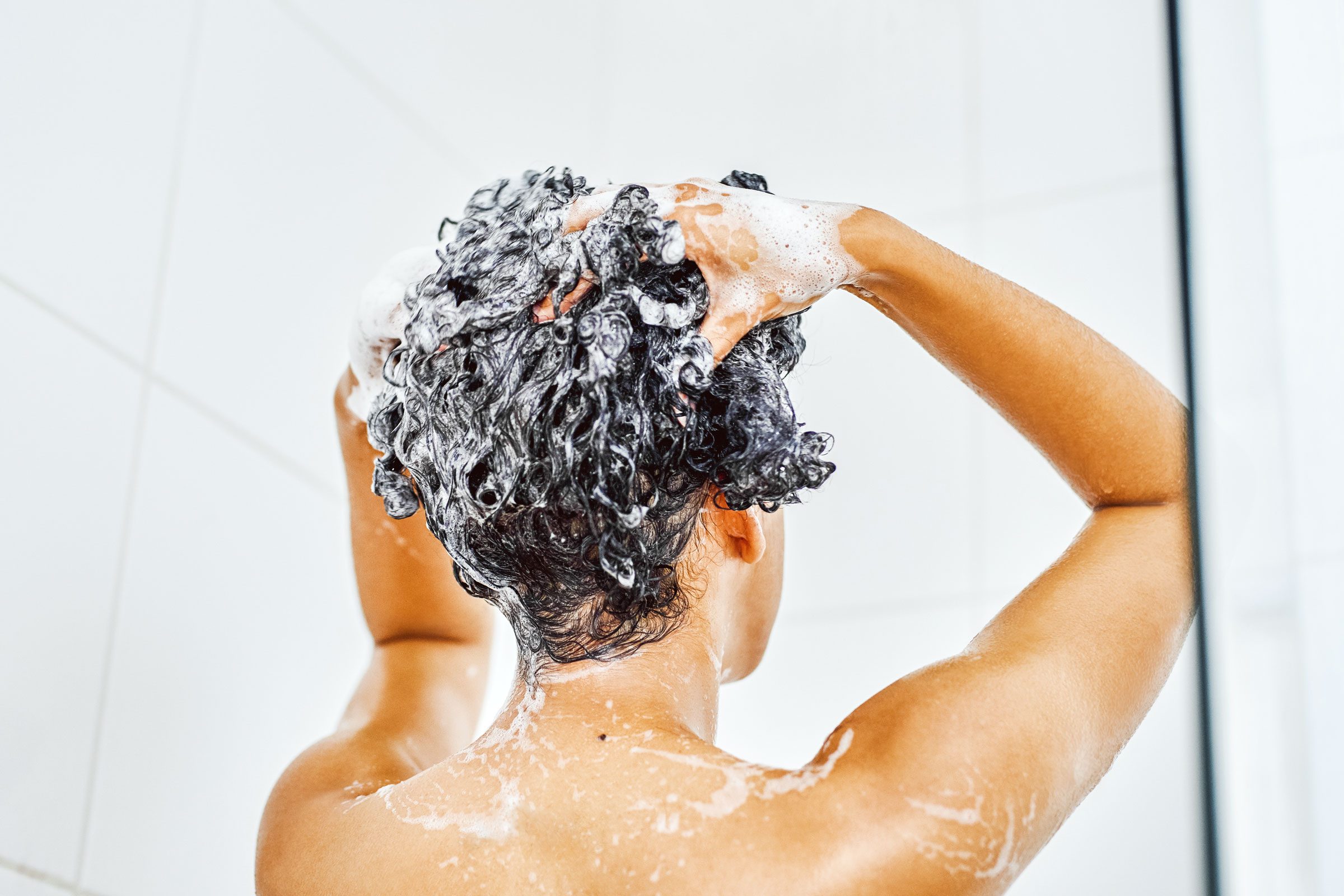 woman washing hair in shower