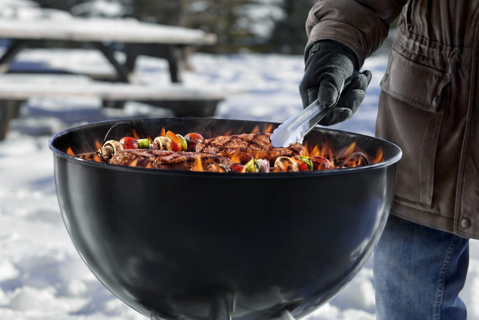 Cooking Steaks and Kabobs on a Backyard BBQ in the Middle of Winter