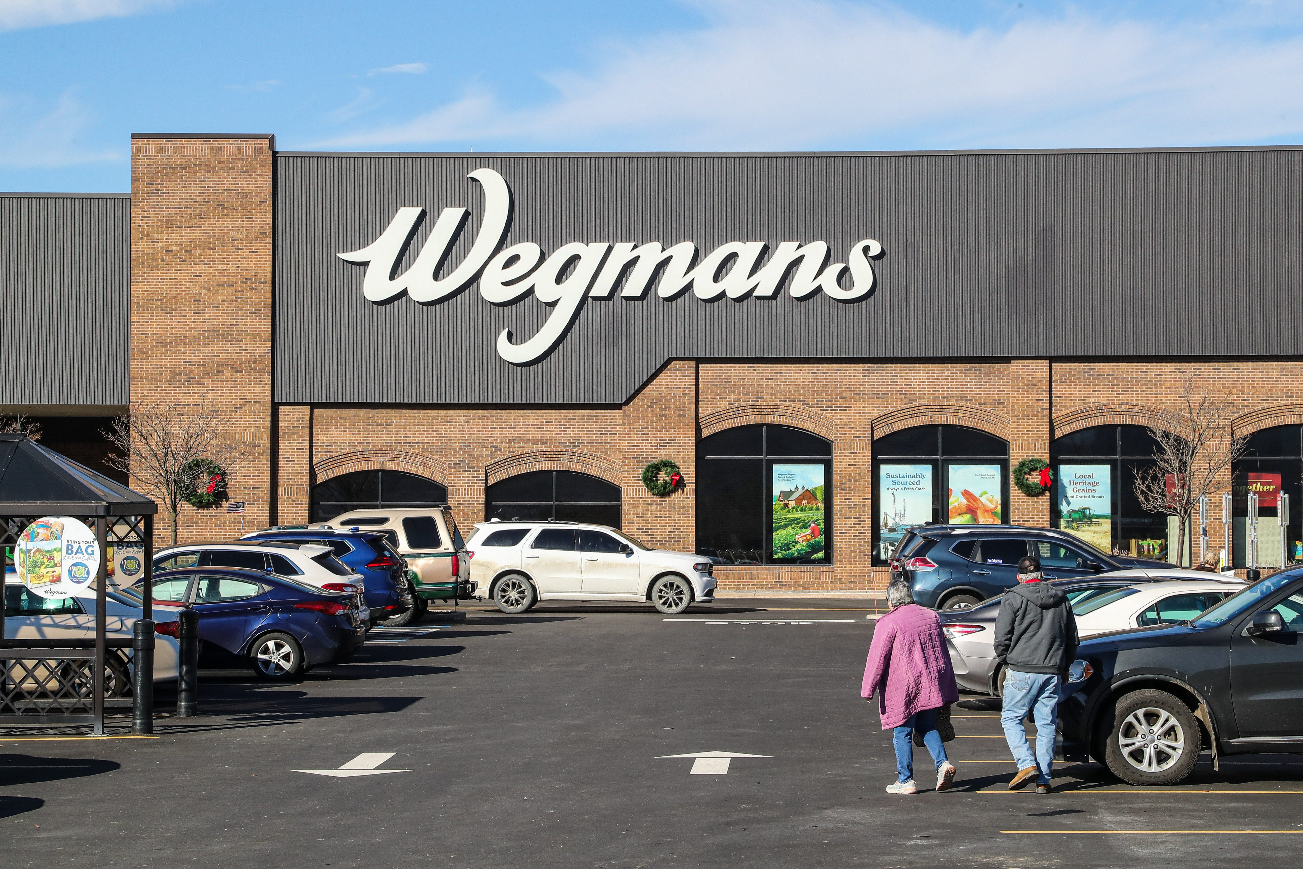 A couple is seen at the parking lot of a Wegmans supermarket...