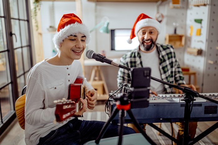 Father and son singing and playing music
