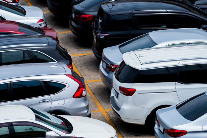 Car parked at the parking lot of the airport for rental. Aerial view of car parking lot of the airport. Used luxury car for sale and rental service. Automobile parking space. Car dealership concept.
