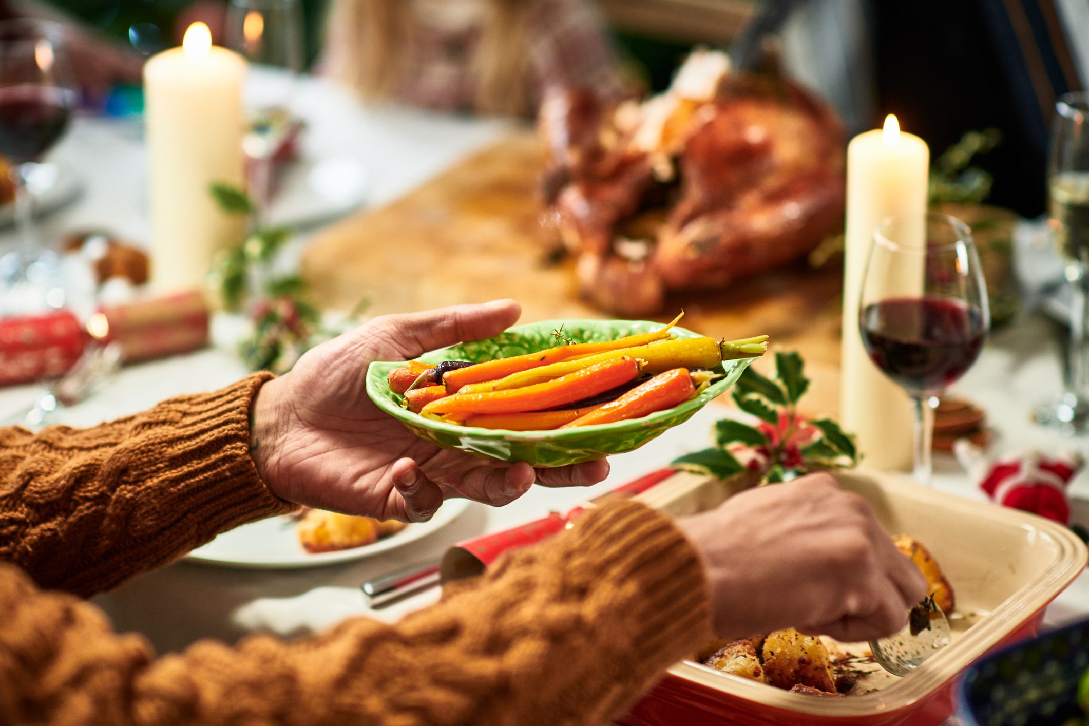 Man holding plate of fresh heritage carrots