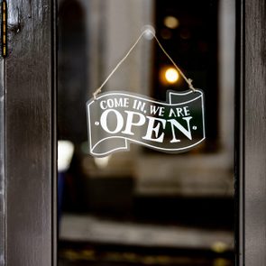 Open sign hanging on the door of a restaurant