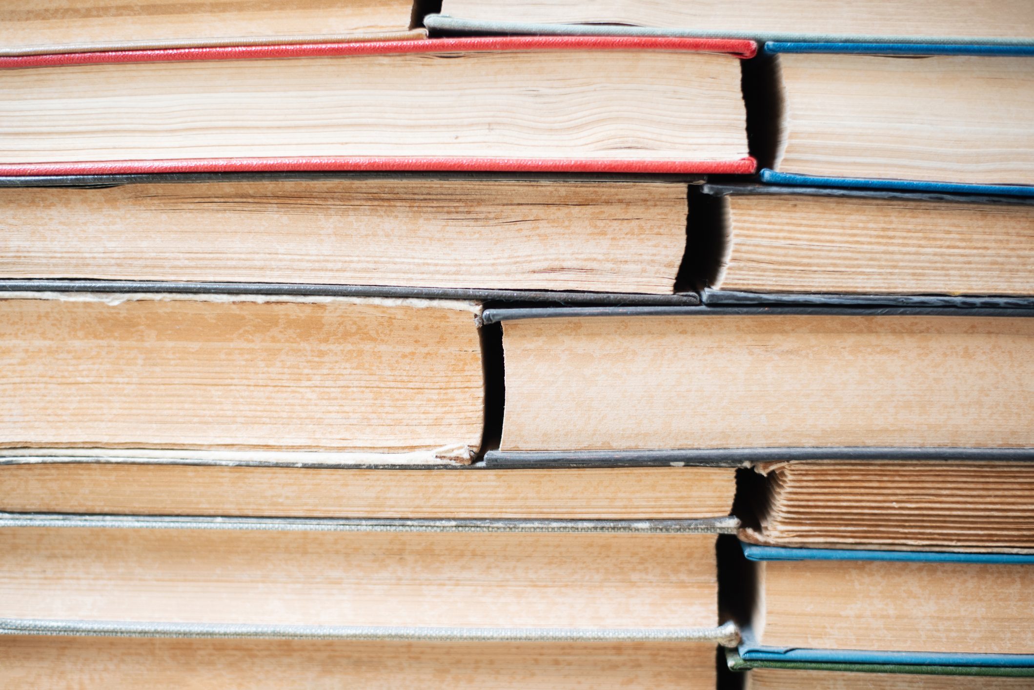 Closed stack of old books. Background from books. Knowledge. School. University. Education.