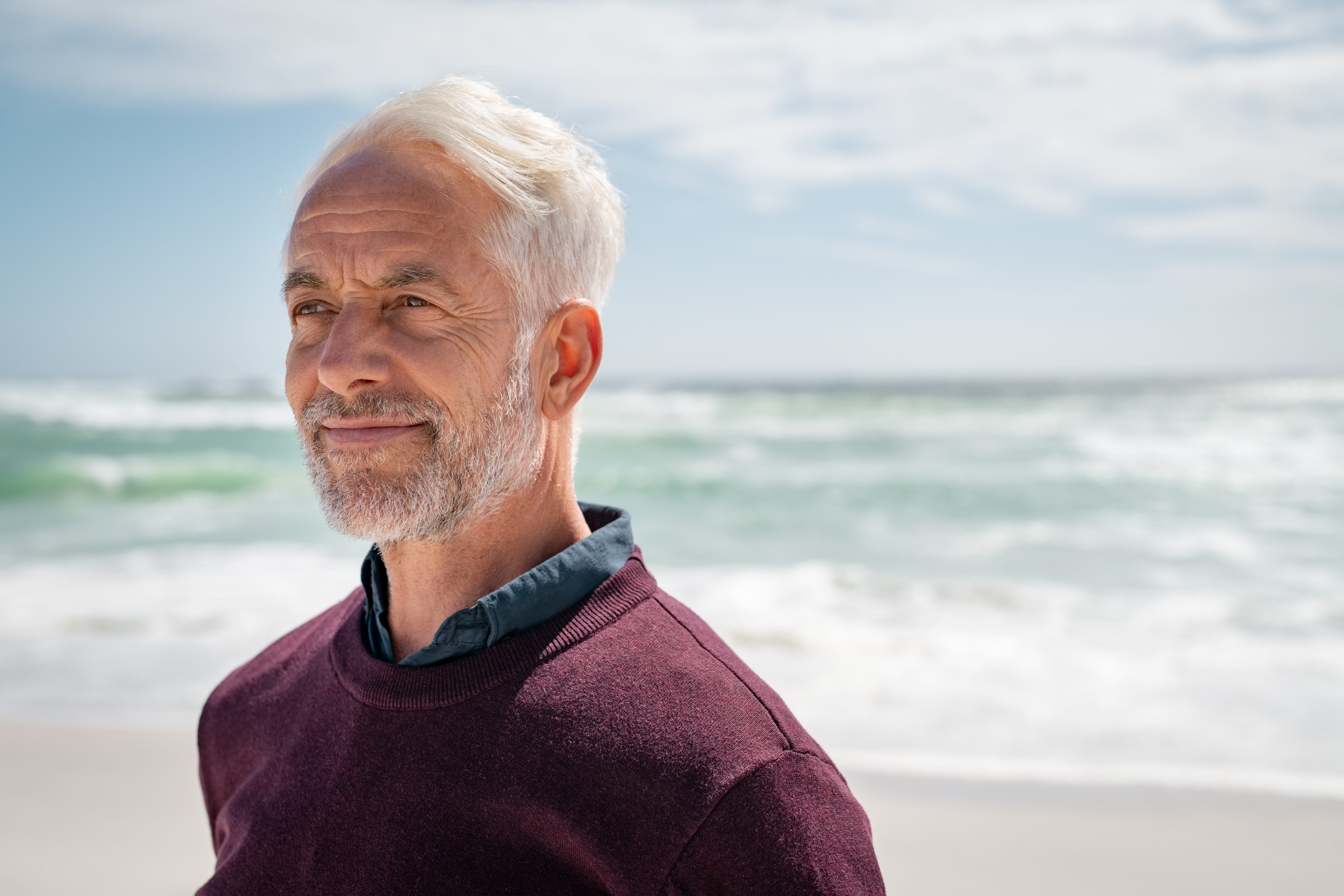 Portrait,of,pensive,senior,man,at,beach,looking,away.,proud