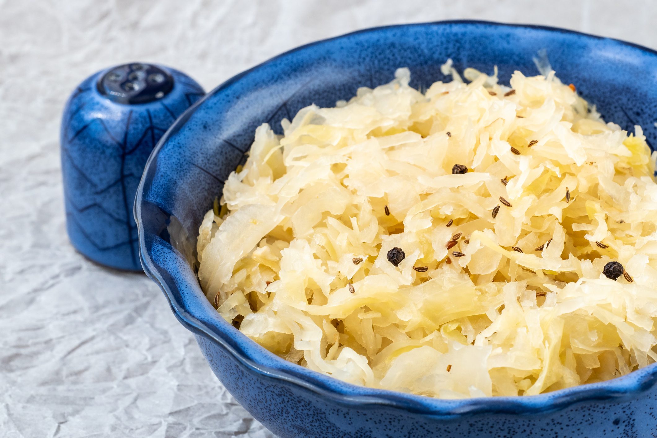 Sauerkraut in a blue bowl. Fresh healthy sauerkraut.