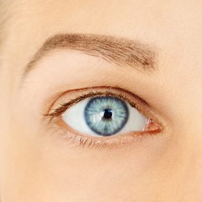 Close-up of female blue eye without make-up