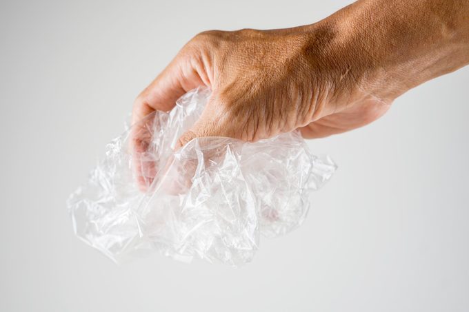 cropped hand in copy space holding unused plastic