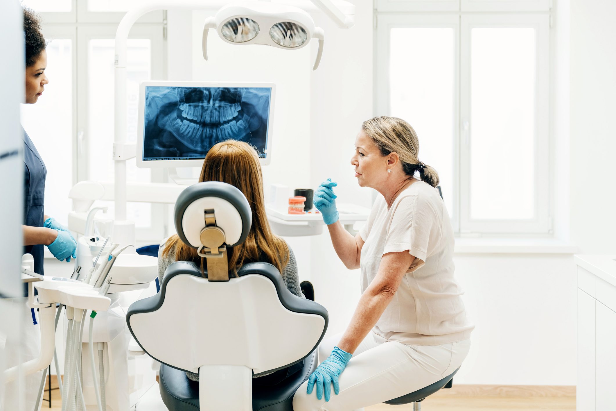 Orthodontist Talking With red hair Patient About Surgery