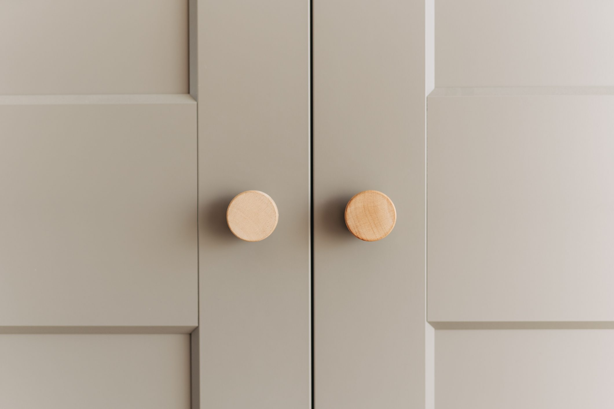 Two crystal handles on white wooden Cabinet doors