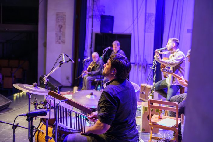 Band of four musicians and singer playing on stage