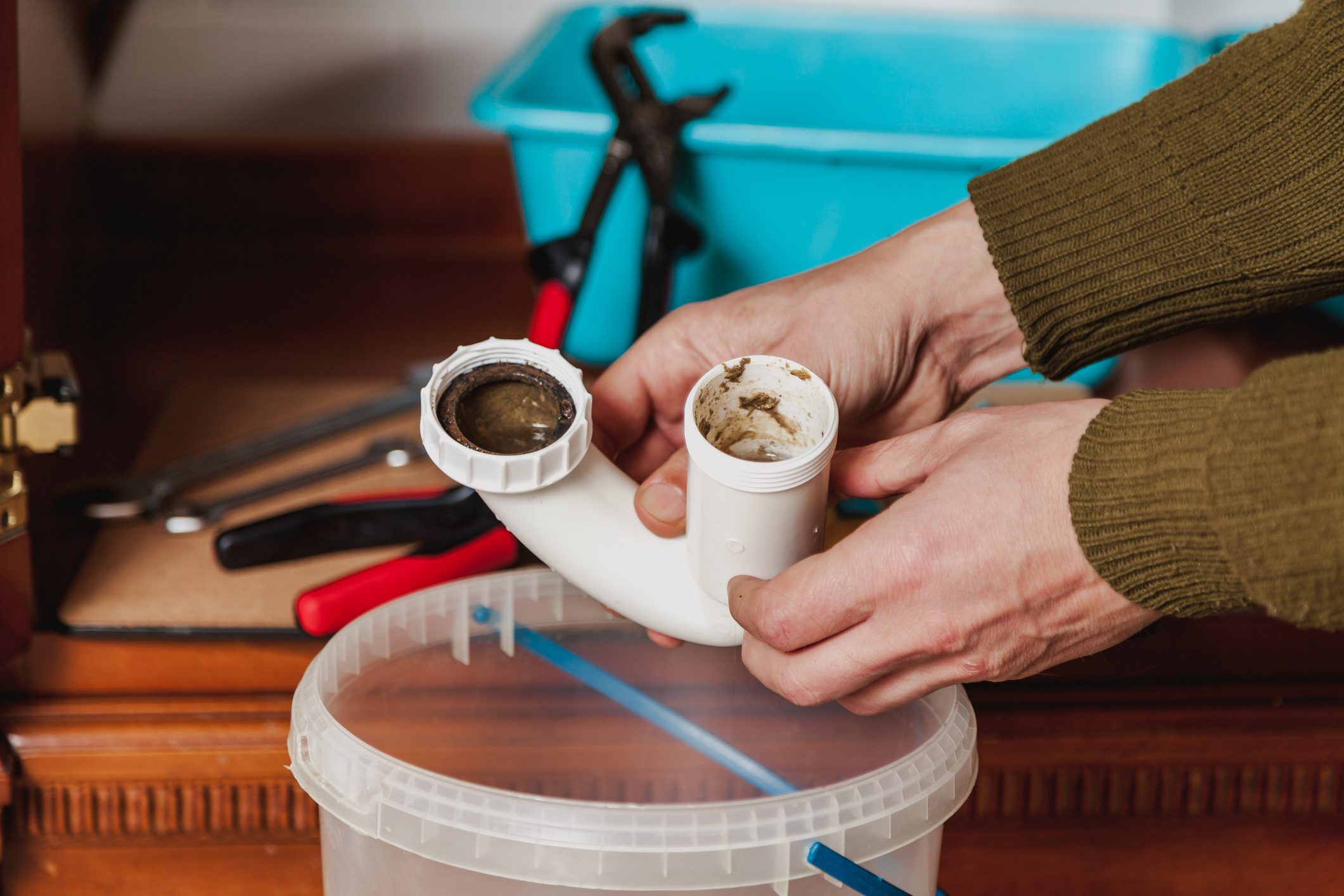 Hands hold detail of hydraulic shutter kitchen sink