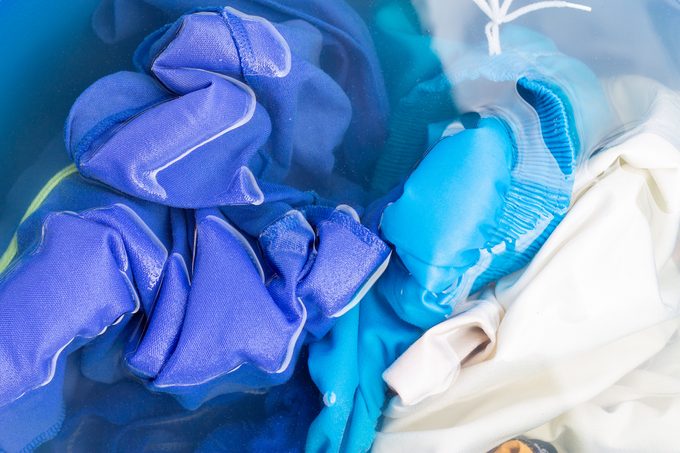 Soak colored clothes before washing them with water.