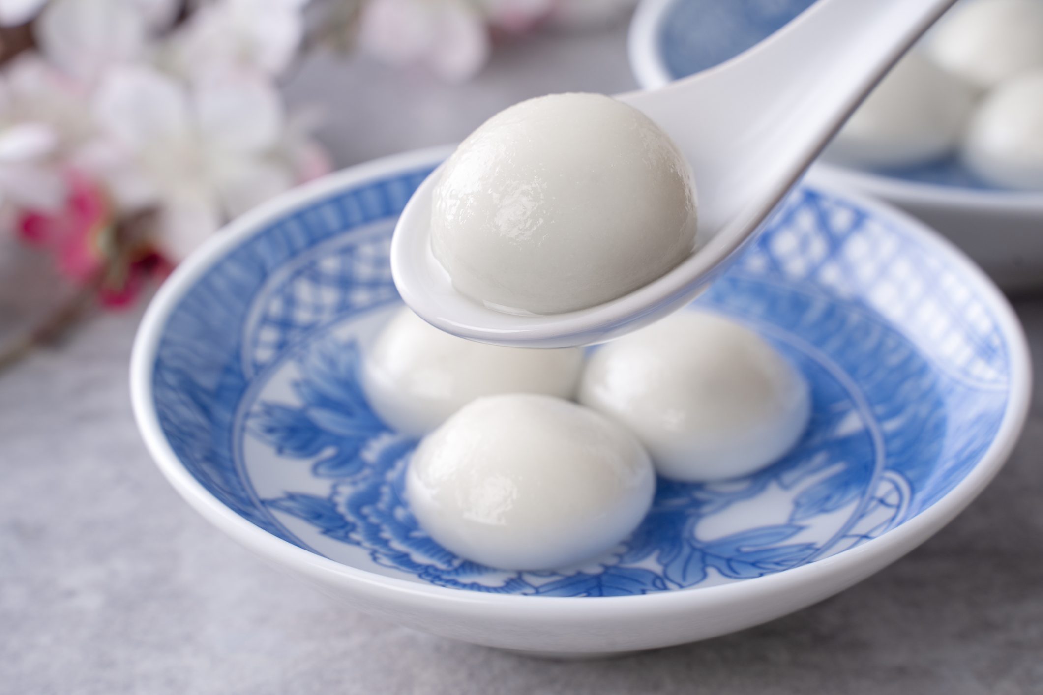 Close up of yuanxiao tangyuan in a bowl on gray table, food for Chinese Lantern Yuanxiao Festival.