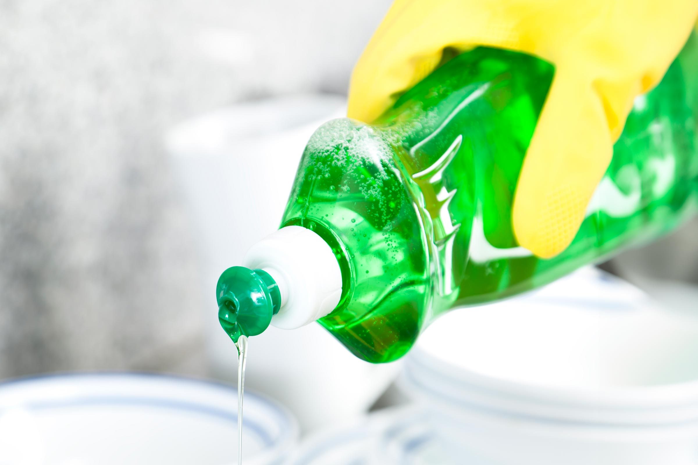 adding dish soap to bowl for cleaning