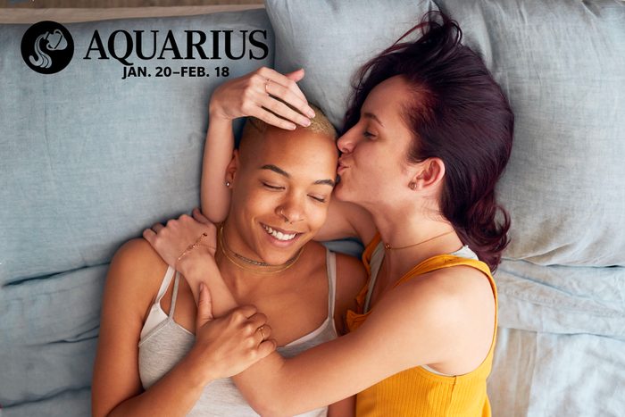 women cuddling in bed