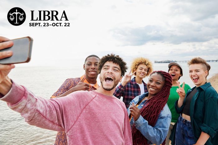 group of friends taking a selfie on a beach