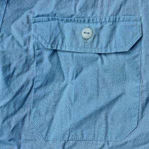 blue fabric texture from crumpled shirt with pocket