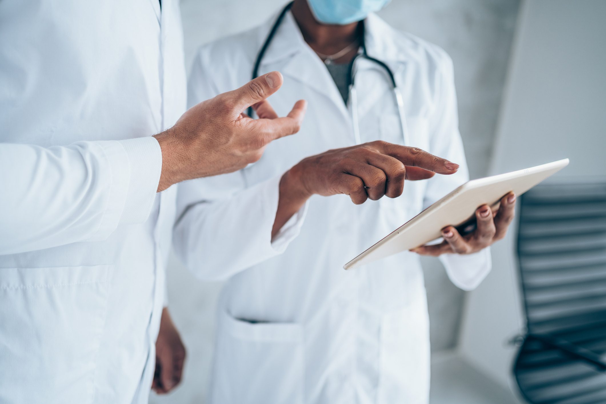 Two doctors having conversation over a case in doctor's office.