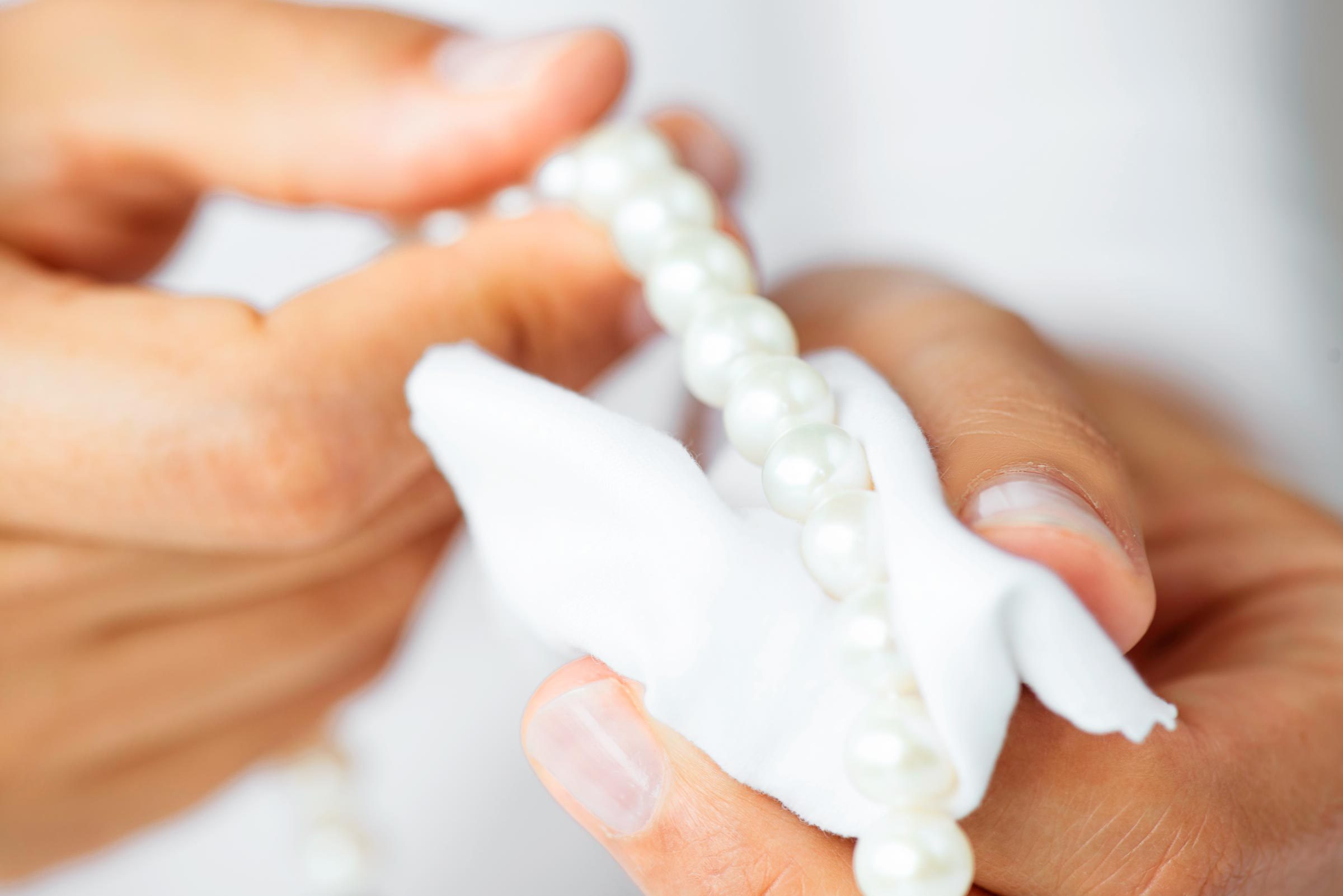 woman with cloth cleaning pearls