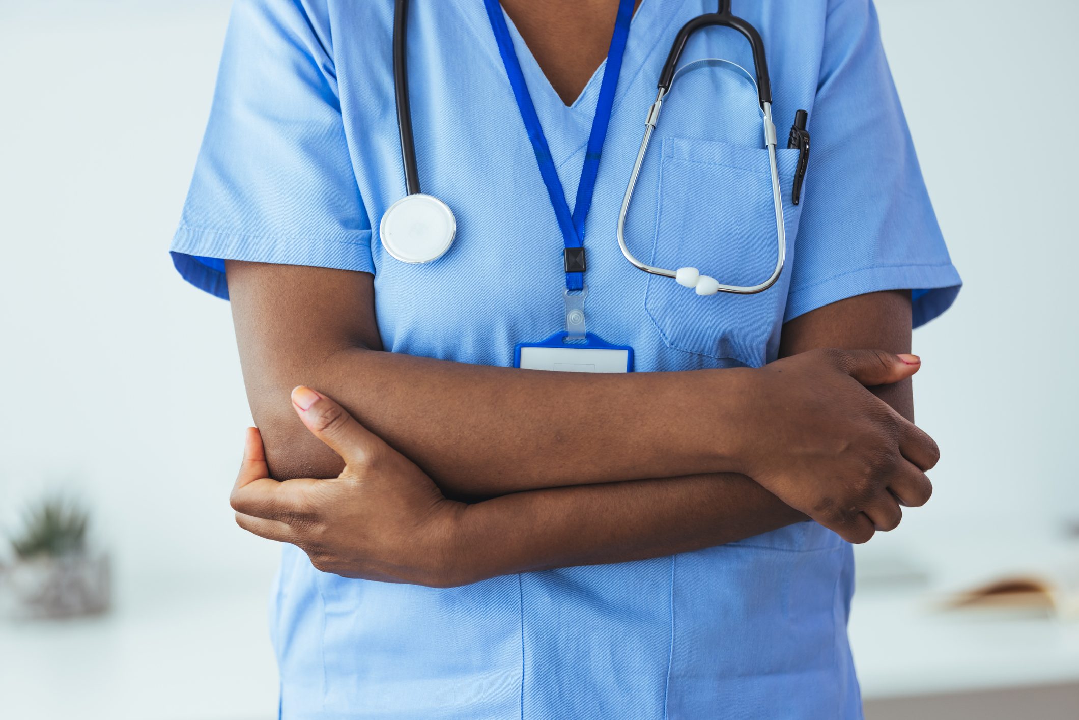 Female nurse standing confidently with her arms crossed