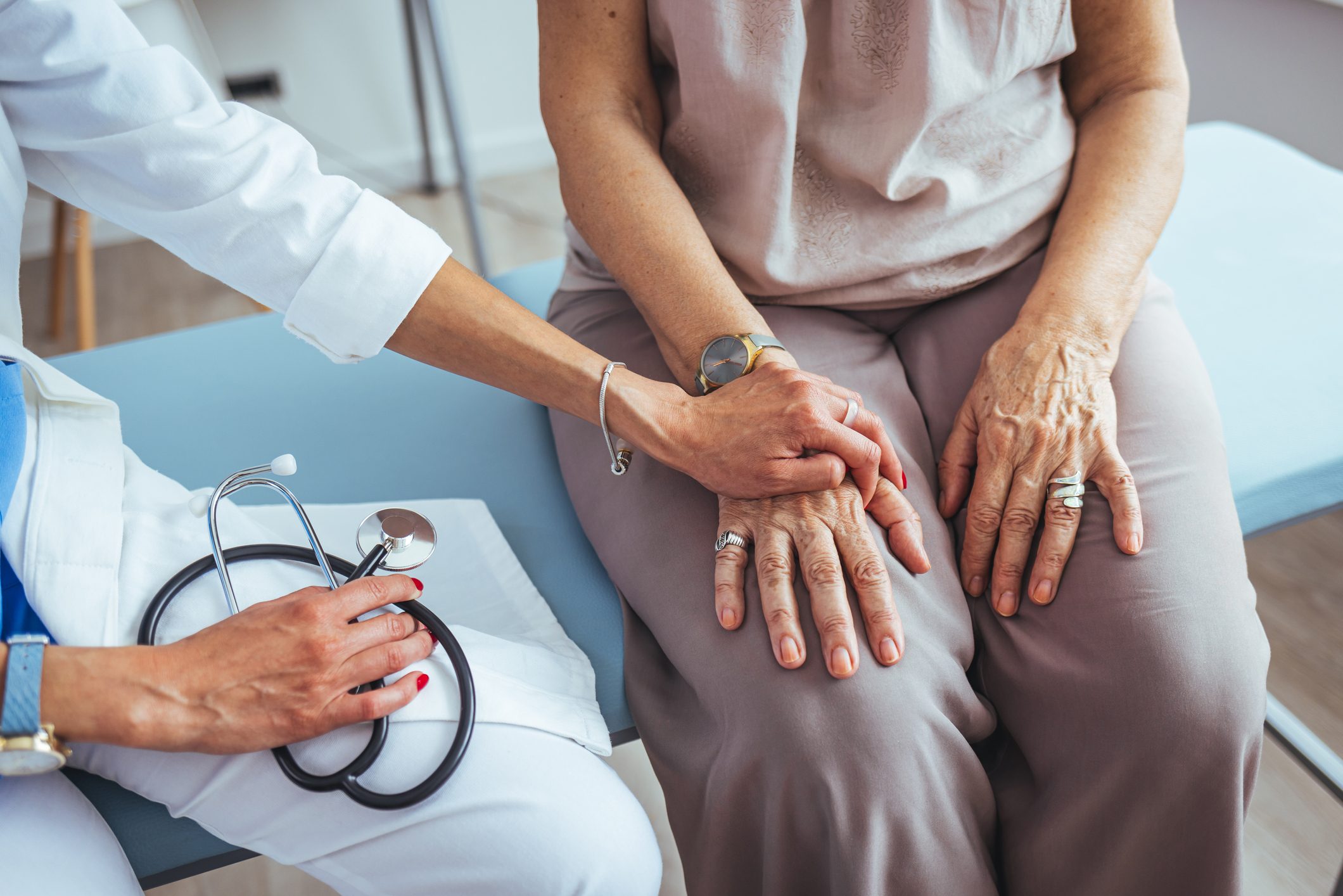 Cropped shot of a female doctor hold her senior patient's hand.