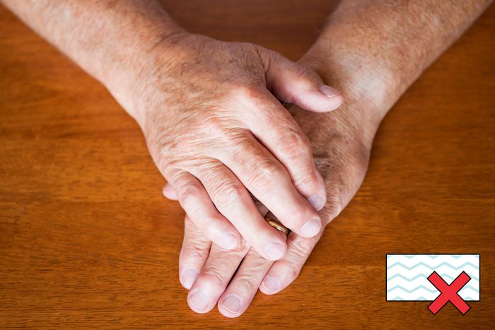 hands on a table with a "no magic eraser symbol" in the corner