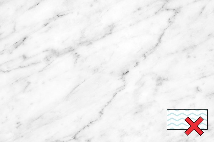 white marble counter with a "no magic eraser symbol" in the corner