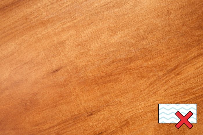 wood surface with a "no magic eraser symbol" in the corner