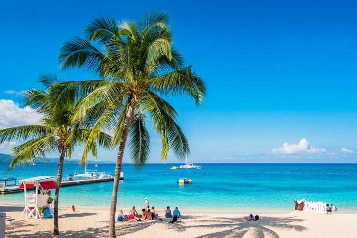 People Enjoy Doctors Cave Beach In Montego Bay Jamaica On A Sunny Day