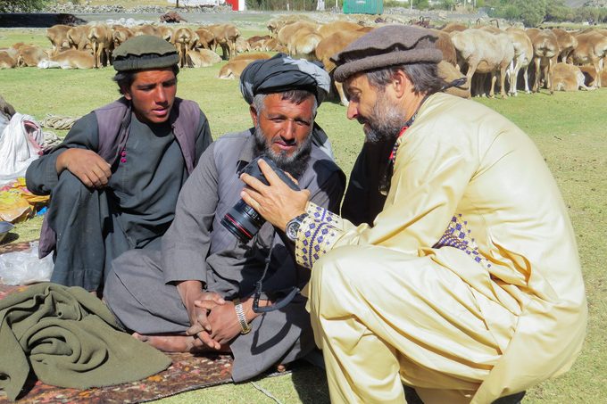 A Man showing other men his camera