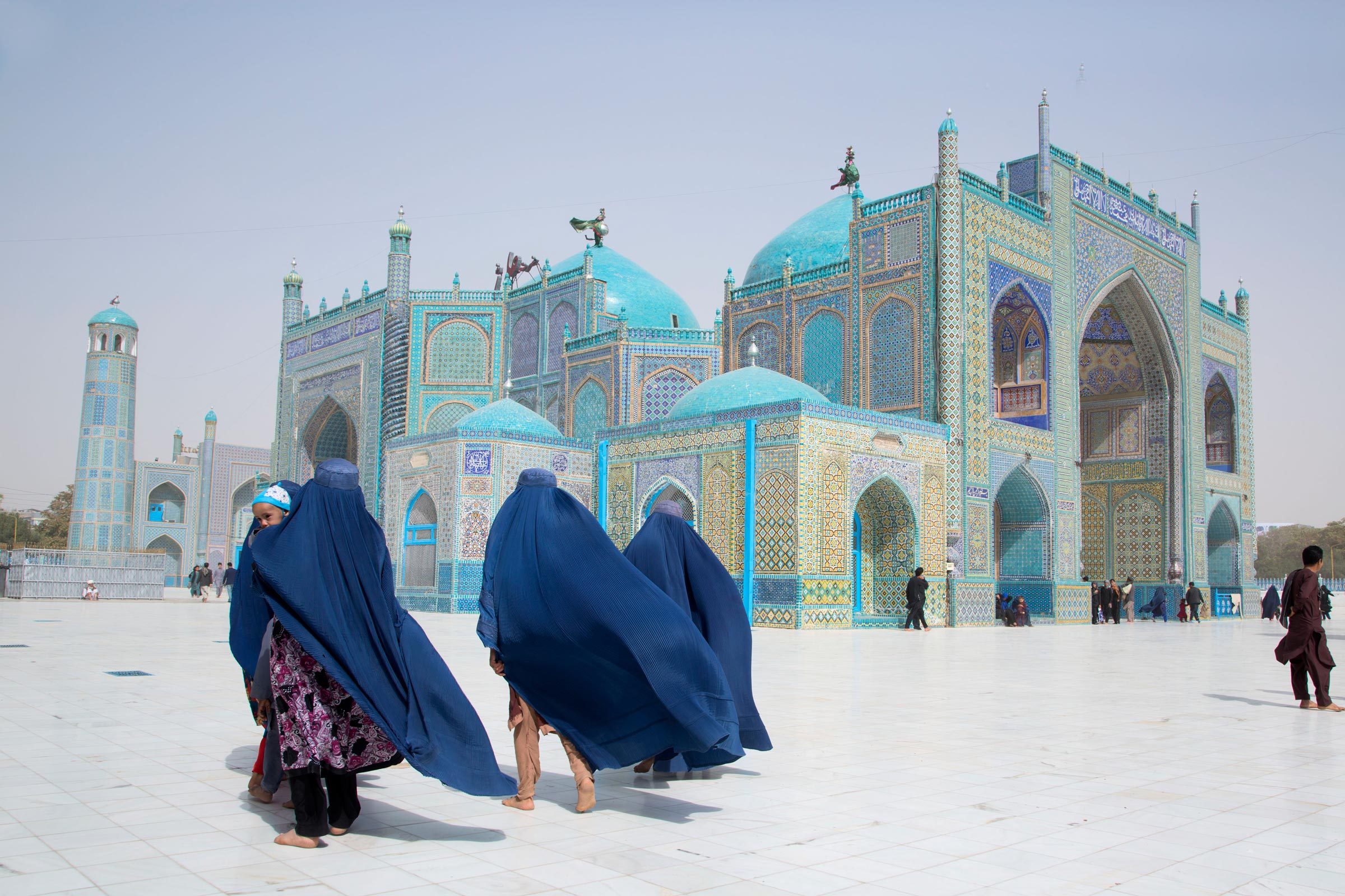 blue mosque with people walking to it