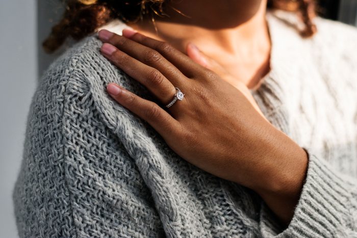 woman's hand with engagement ring