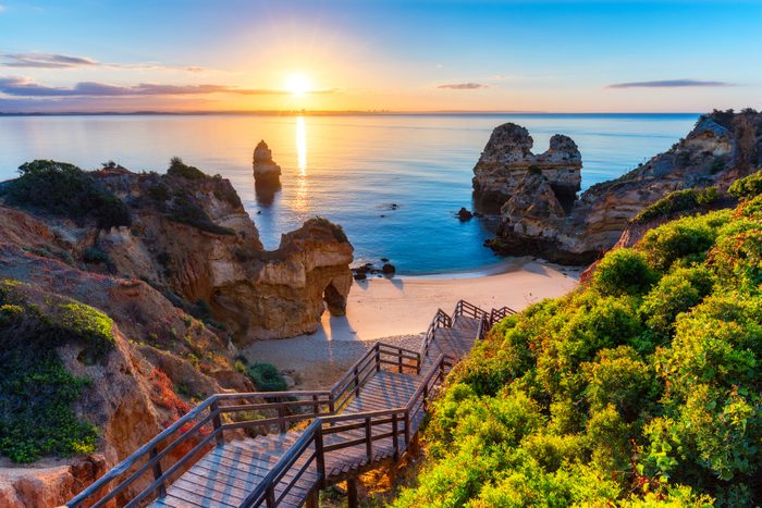 Camilo Beach (Praia do Camilo) at Algarve, Portugal with turquoise sea in background. Wooden footbridge to beach Praia do Camilo, Portugal. Wonderful view of Camilo Beach in Lagos, Algarve, Portugal.