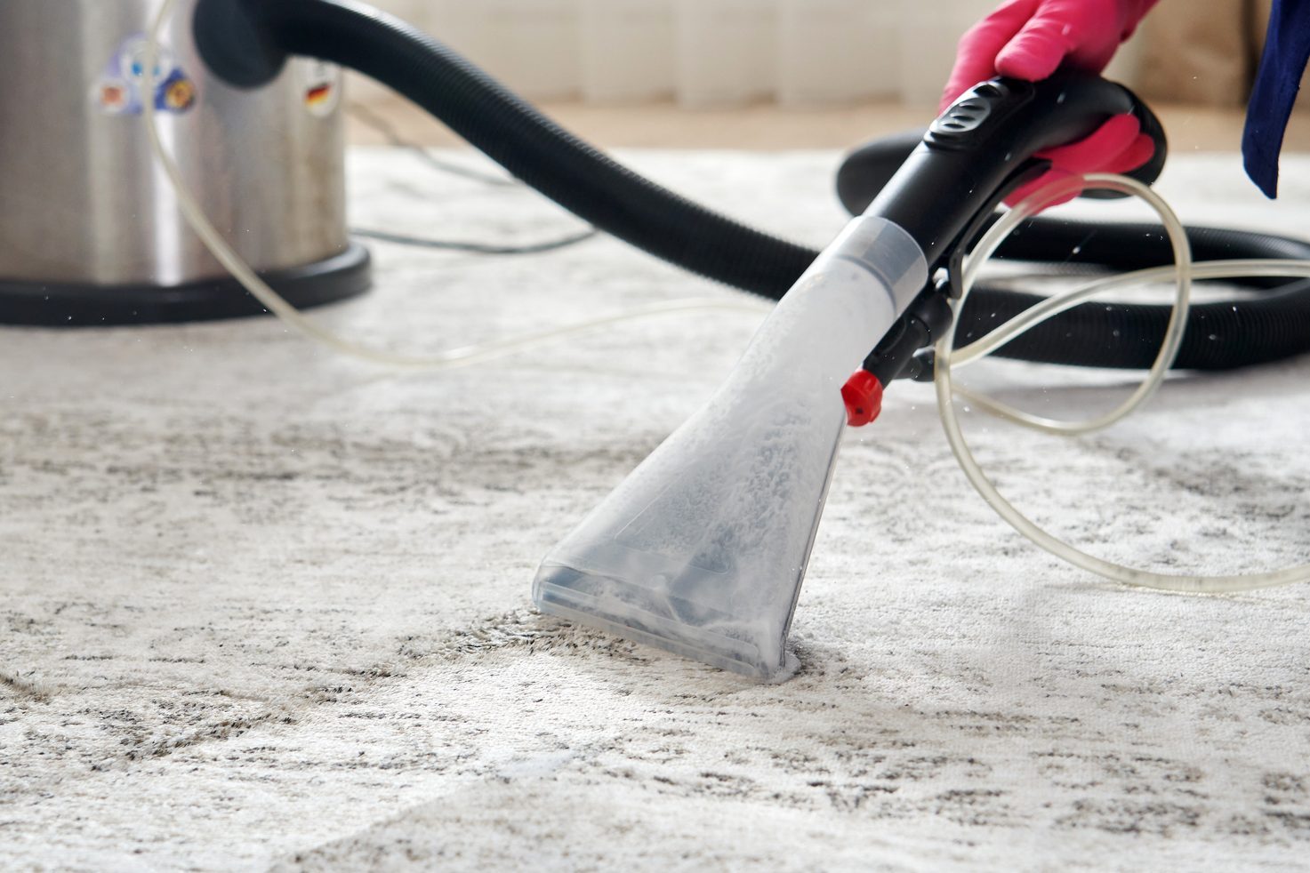 Human Cleaning Carpet In The Living Room Using Vacuum Cleaner At Home