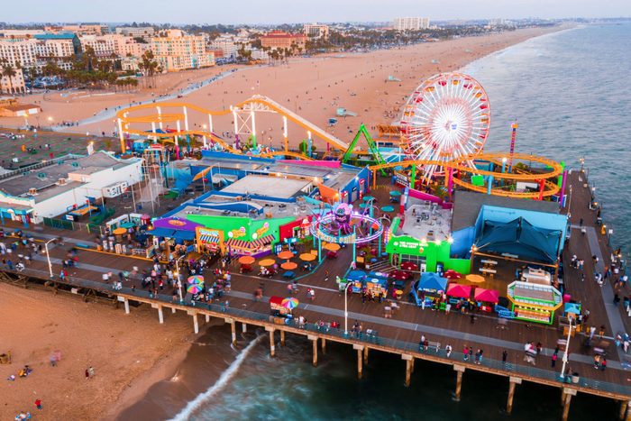 Santa Monica Pier at sundown with lights reflected in the Pacific Ocean